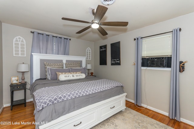 bedroom with hardwood / wood-style flooring, ceiling fan, and cooling unit