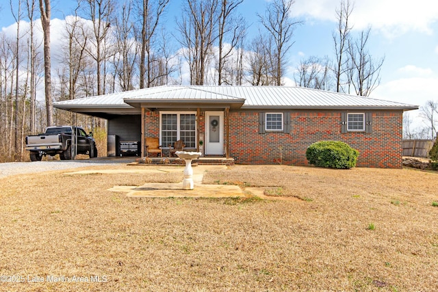 ranch-style home with a carport and a front lawn