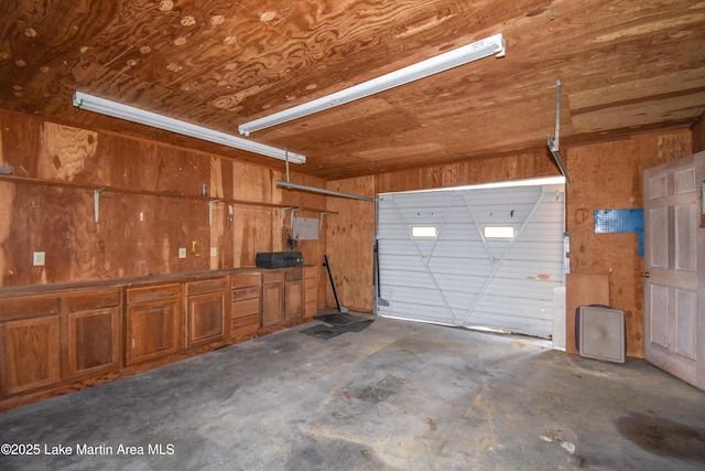 garage with wood ceiling and wood walls