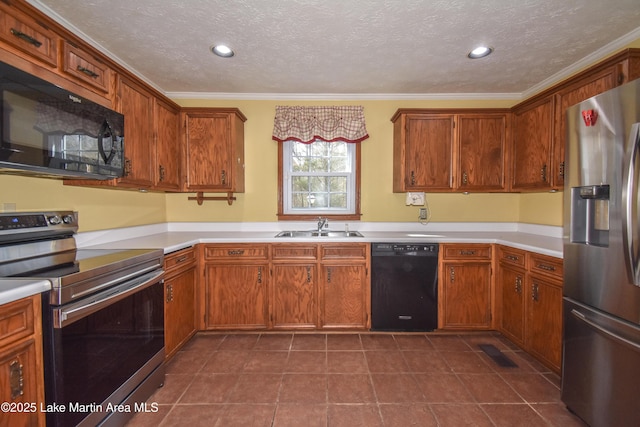 kitchen featuring sink, a textured ceiling, dark tile patterned flooring, black appliances, and crown molding