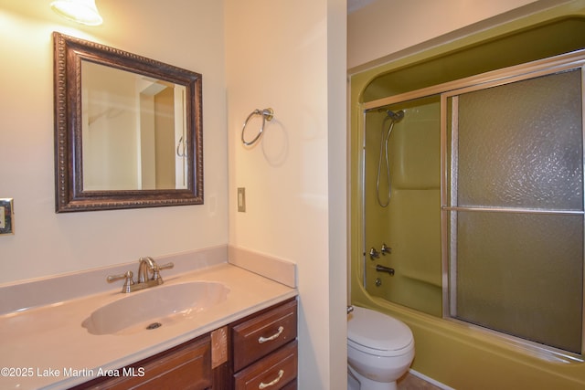 full bathroom with toilet, bath / shower combo with glass door, and vanity