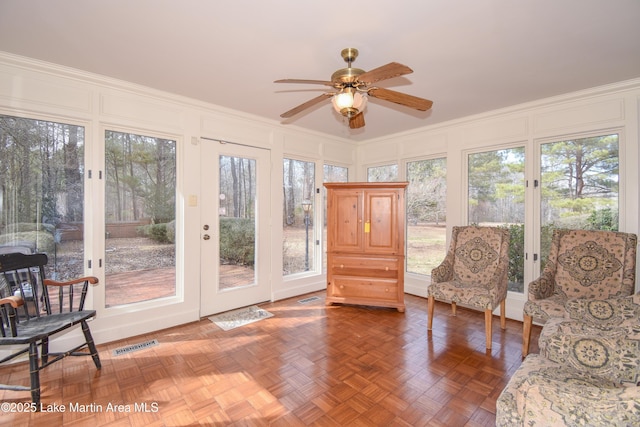 sunroom featuring ceiling fan