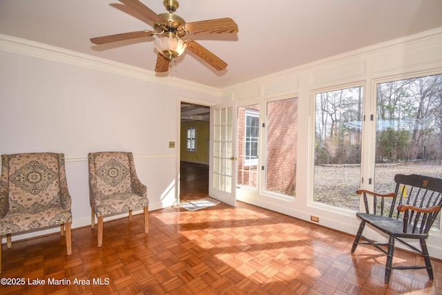 sitting room featuring parquet floors, ceiling fan, and crown molding