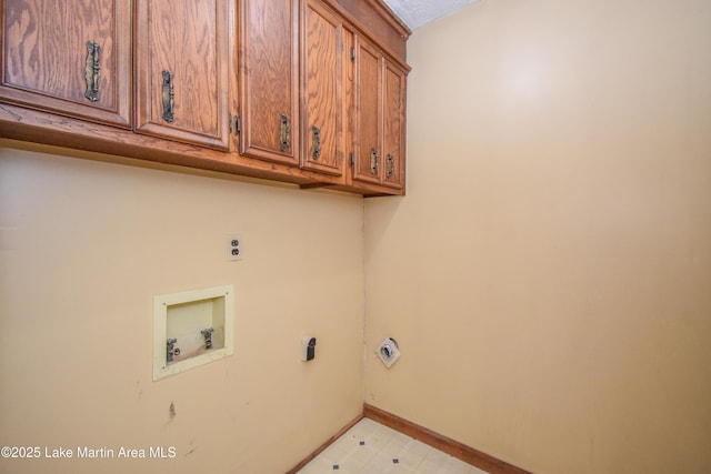 clothes washing area with cabinets, hookup for a washing machine, and electric dryer hookup