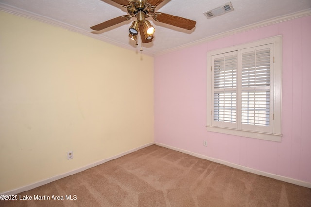 carpeted empty room with ceiling fan and crown molding