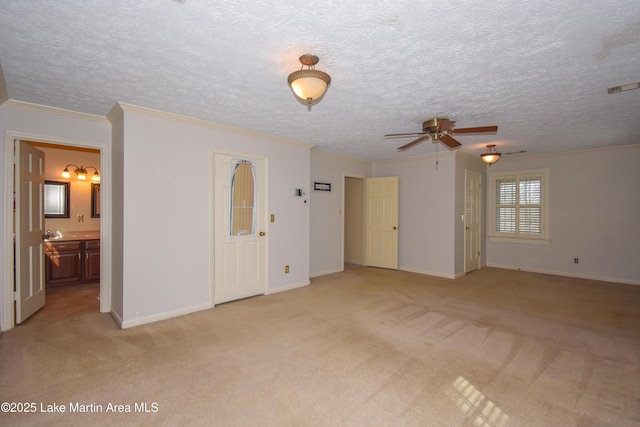 interior space with a textured ceiling, ceiling fan, and ornamental molding