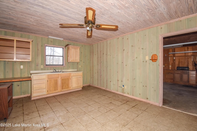 kitchen featuring crown molding, wooden ceiling, light brown cabinetry, and sink