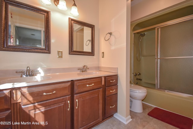 full bathroom featuring shower / bath combination with glass door, vanity, and toilet