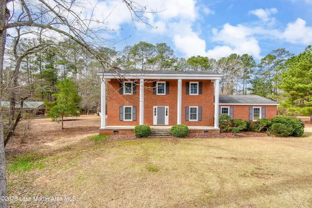 greek revival house featuring crawl space, a front lawn, and brick siding