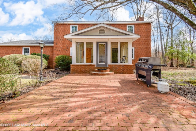 view of front property featuring a patio and a sunroom