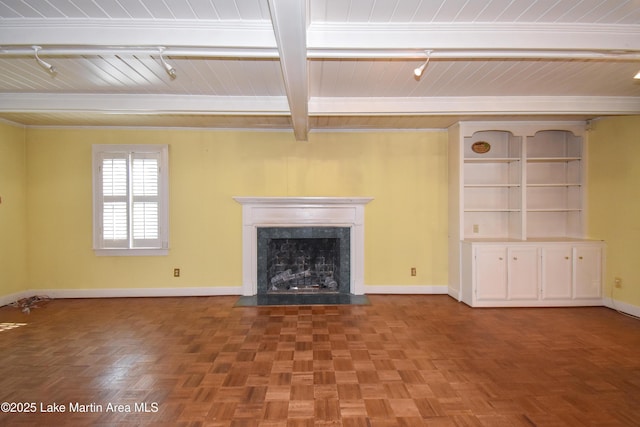 unfurnished living room with beamed ceiling, parquet floors, and a premium fireplace