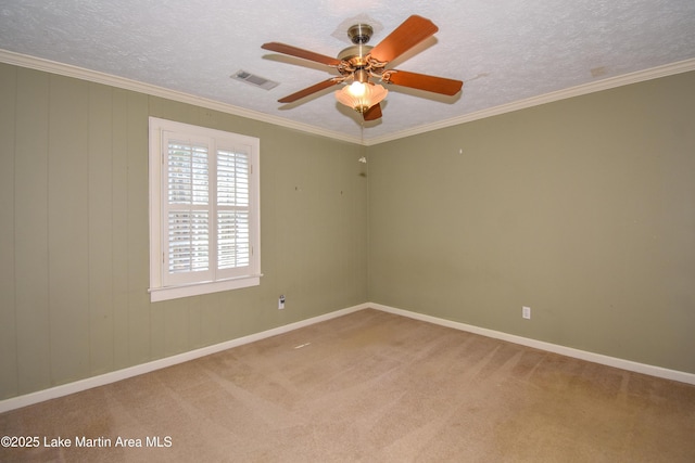 spare room featuring a textured ceiling, ceiling fan, carpet flooring, and ornamental molding