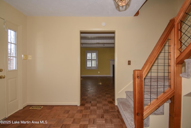 foyer with dark parquet floors