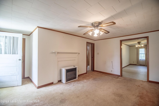 unfurnished living room with crown molding, light colored carpet, ceiling fan, and heating unit