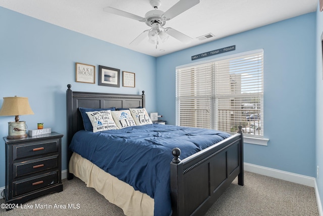 bedroom with ceiling fan and light colored carpet