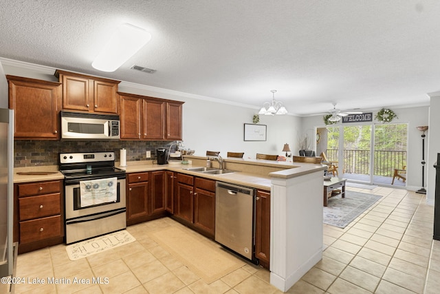 kitchen featuring ornamental molding, ceiling fan with notable chandelier, stainless steel appliances, sink, and light tile patterned flooring