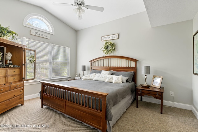 bedroom with multiple windows, ceiling fan, light carpet, and vaulted ceiling