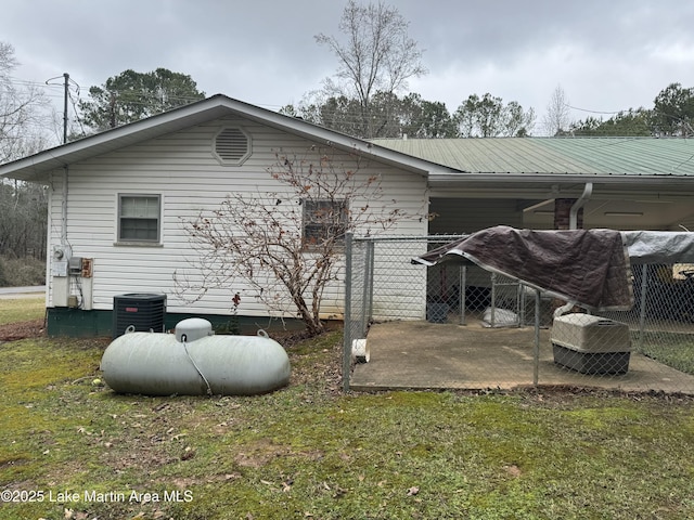 back of house featuring a yard and cooling unit