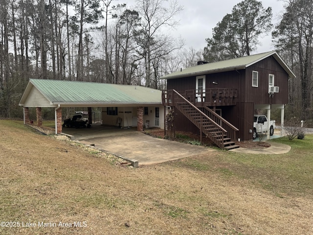 view of front of house with a carport, cooling unit, a wooden deck, and a front lawn