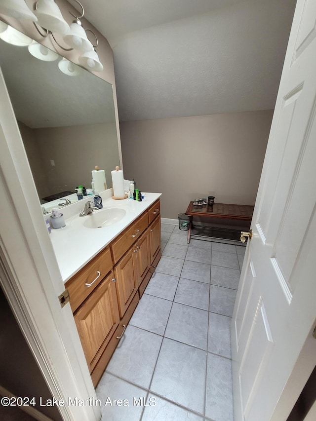 bathroom featuring tile patterned flooring and vanity