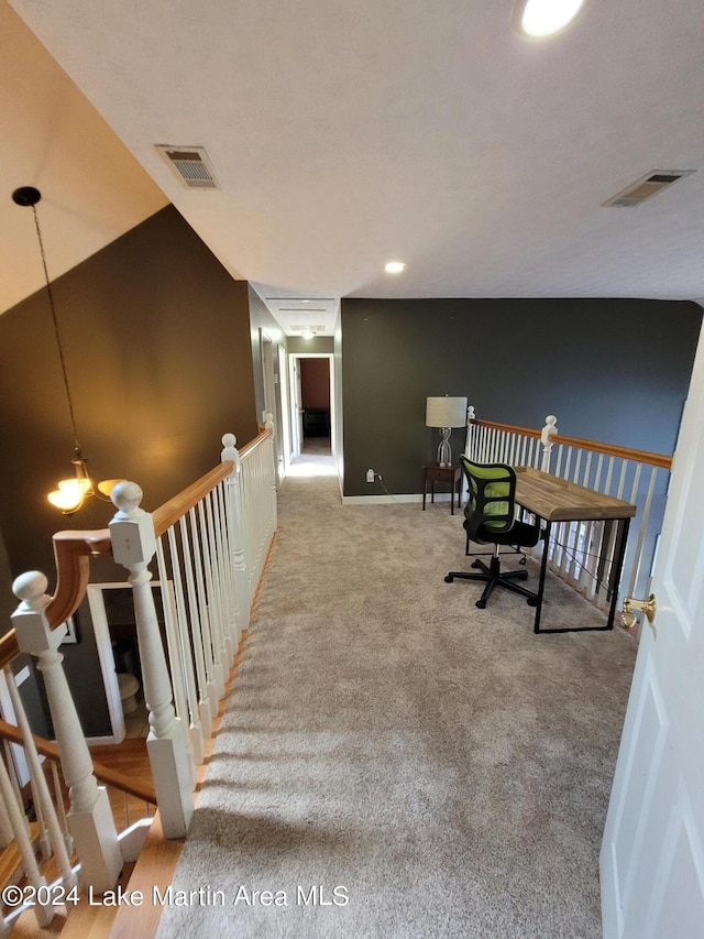 office space featuring carpet floors and an inviting chandelier