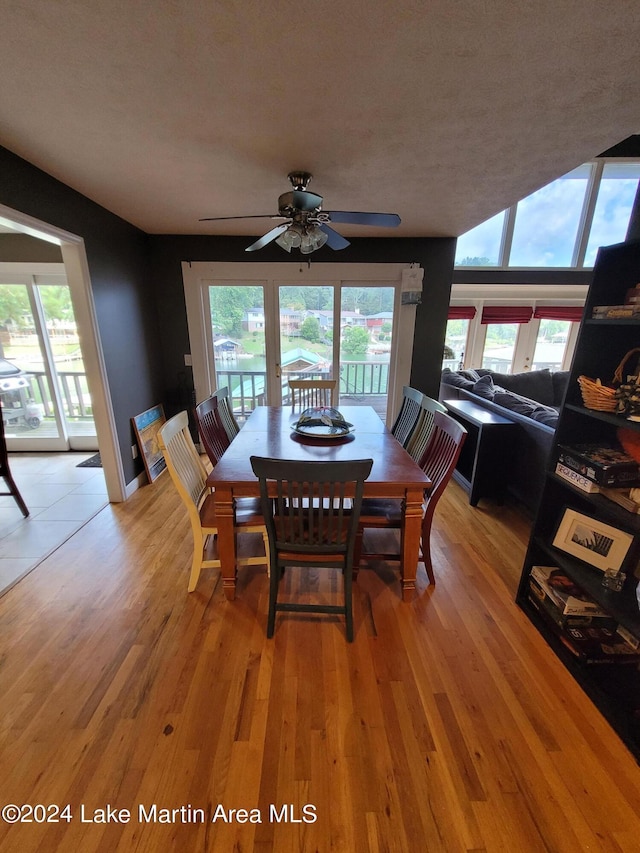 dining area with a textured ceiling, light hardwood / wood-style flooring, and ceiling fan