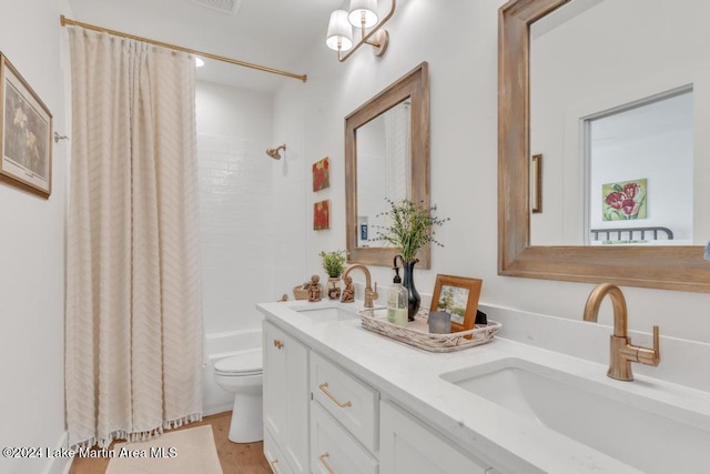 full bathroom with vanity, toilet, wood-type flooring, and shower / tub combo