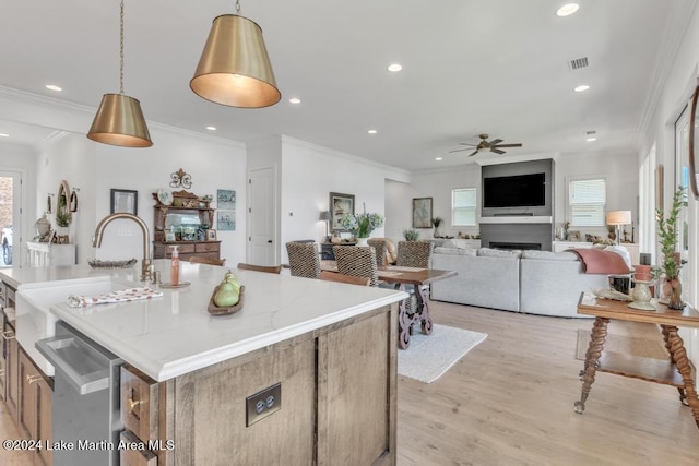 218 Williams Rd, Alexander City, AL 35010 - kitchen featuring a sink, a ceiling fan, hanging light fixtures, visible vents, and light wood-style floors