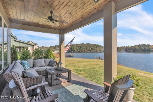 view of patio featuring an outdoor living space, ceiling fan, and a water view