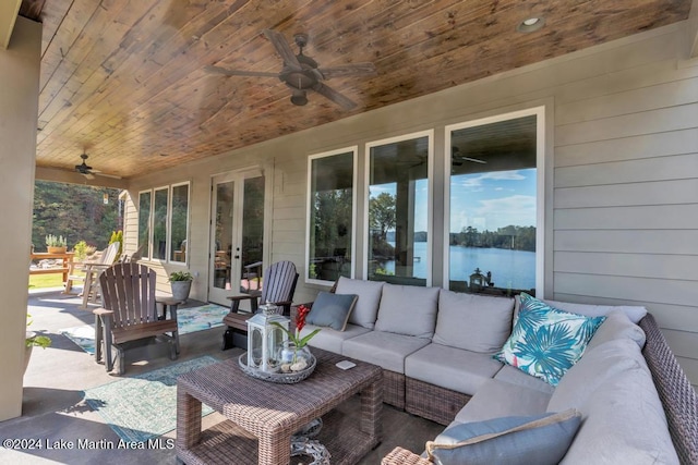 view of patio / terrace with outdoor lounge area, ceiling fan, french doors, and a water view