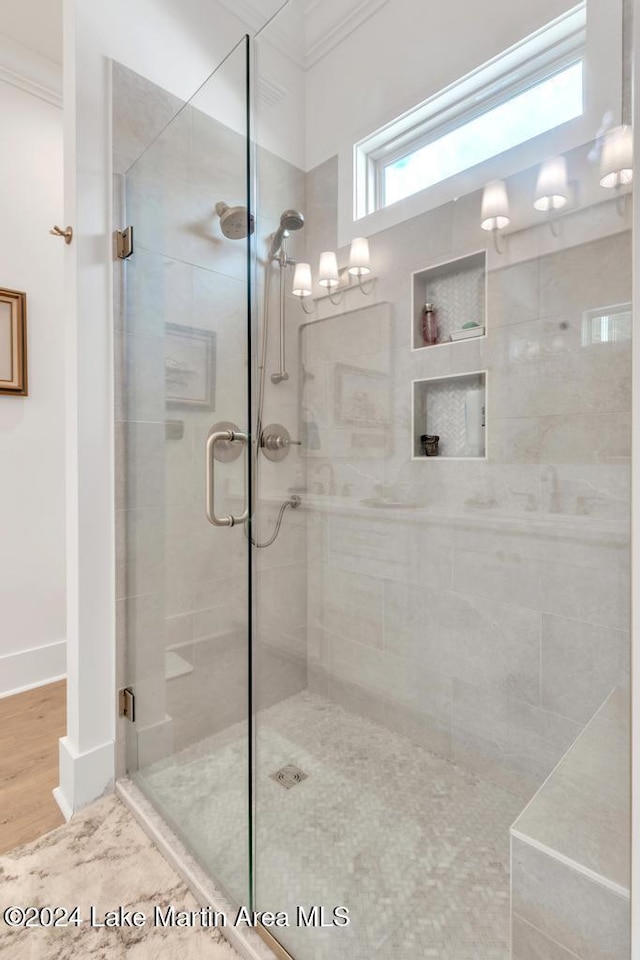 bathroom featuring hardwood / wood-style floors, an enclosed shower, and crown molding