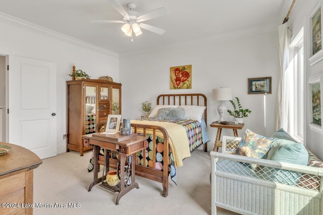 carpeted bedroom with ceiling fan and ornamental molding