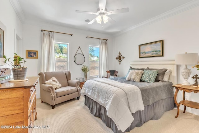 carpeted bedroom with ceiling fan and crown molding