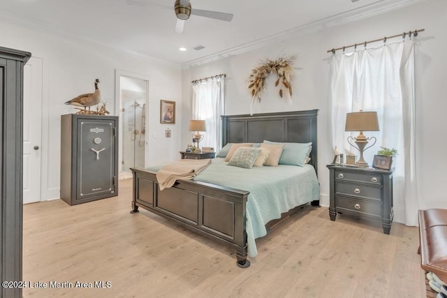 bedroom with connected bathroom, light hardwood / wood-style floors, ceiling fan, and ornamental molding