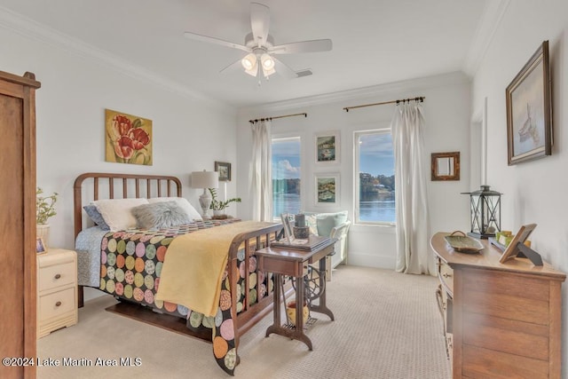 carpeted bedroom with ceiling fan and ornamental molding