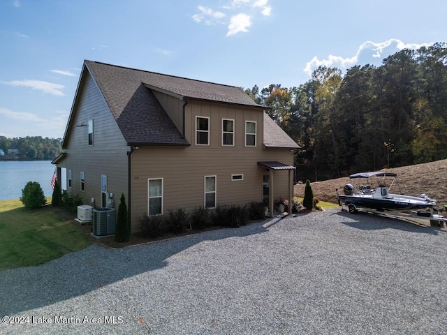 view of home's exterior featuring a water view and central AC unit