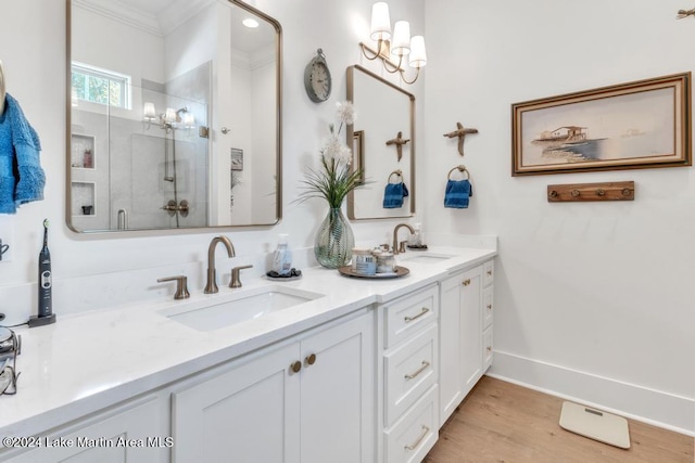 bathroom featuring crown molding, a shower with door, vanity, and wood-type flooring