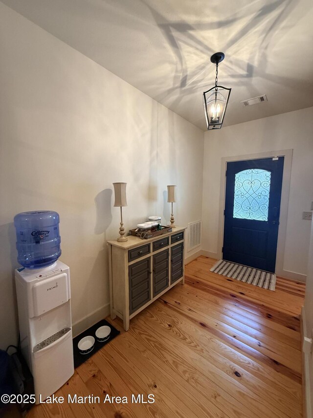43 Shady Cv, Dadeville, AL 36853 - foyer entrance featuring light wood finished floors and a chandelier