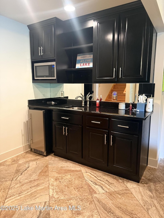 43 Shady Cv, Dadeville, AL 36853 - kitchen featuring stainless steel microwave, dark cabinets, dark countertops, dishwashing machine, and open shelves