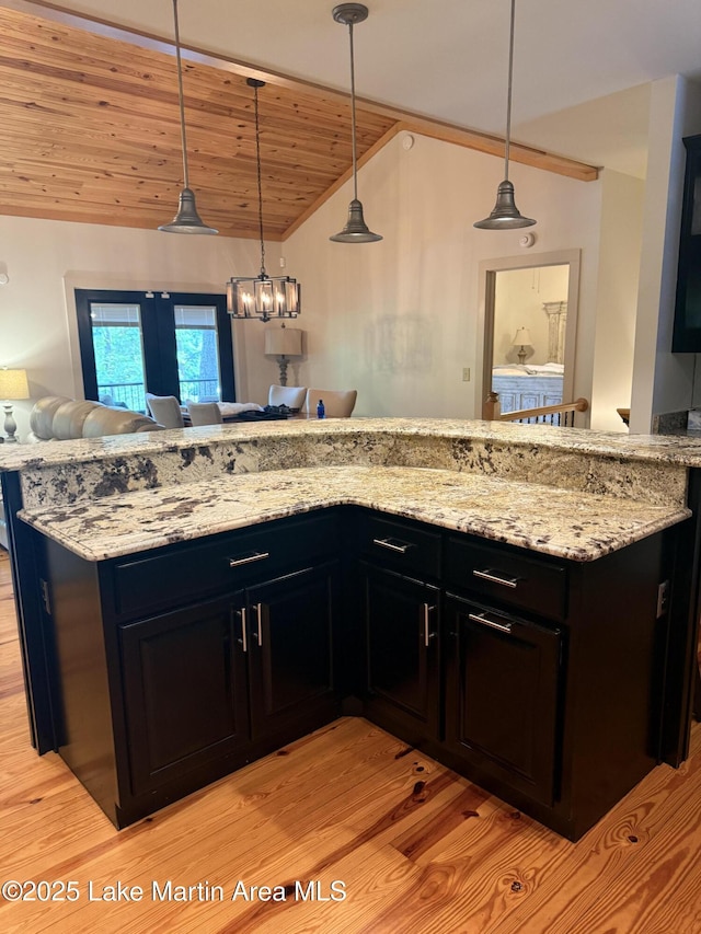 43 Shady Cv, Dadeville, AL 36853 - kitchen with lofted ceiling, light wood finished floors, wooden ceiling, light stone countertops, and hanging light fixtures