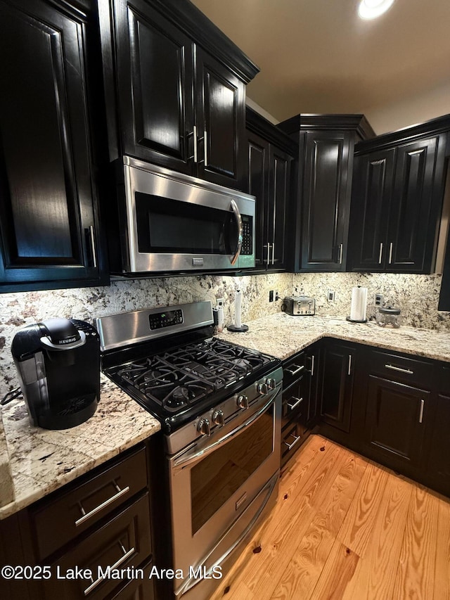 43 Shady Cv, Dadeville, AL 36853 - kitchen featuring stainless steel appliances, dark cabinets, and light stone counters