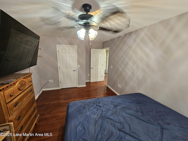 bedroom with ceiling fan and dark wood-type flooring