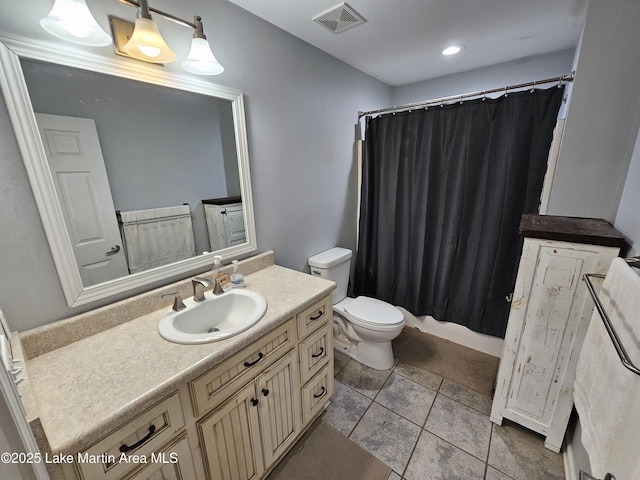 bathroom featuring toilet, tile patterned flooring, vanity, and curtained shower