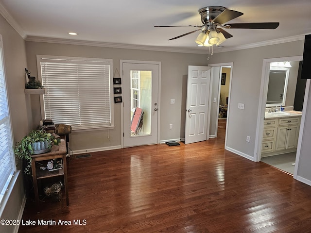 entryway featuring ceiling fan, sink, hardwood / wood-style floors, and ornamental molding