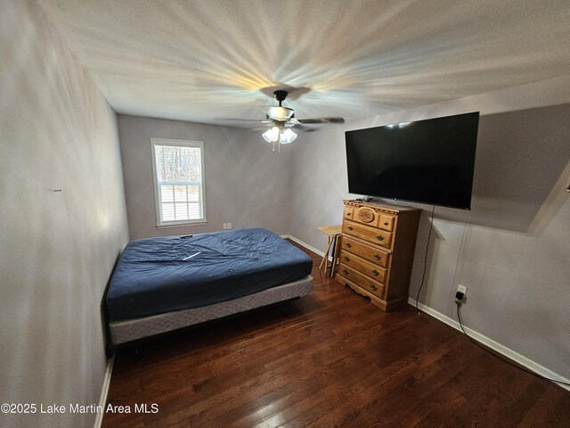 bedroom featuring ceiling fan and dark hardwood / wood-style flooring