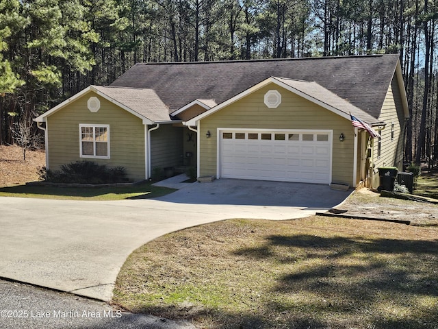 view of front of home with a garage and cooling unit