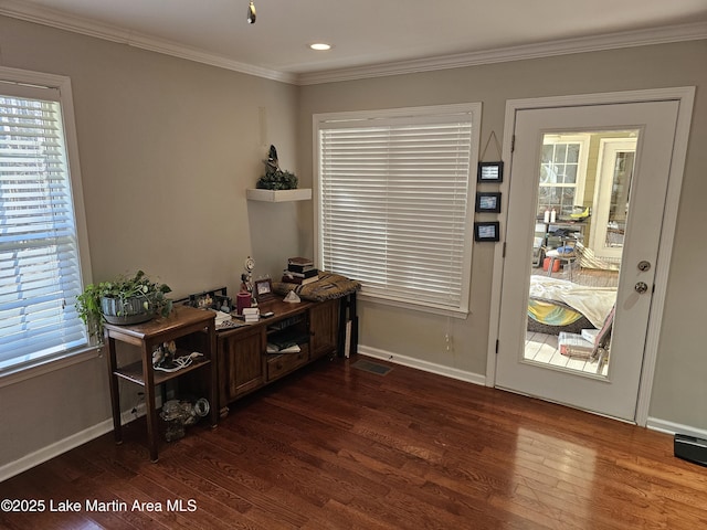 entryway featuring crown molding and dark hardwood / wood-style floors