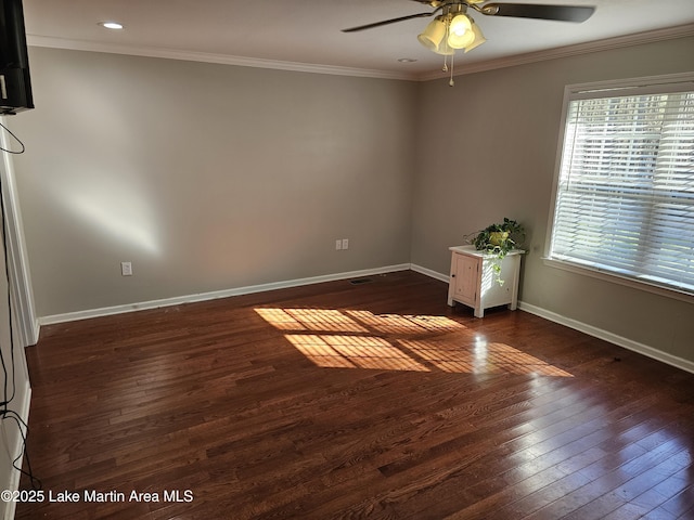 empty room with ceiling fan, dark wood-type flooring, and ornamental molding