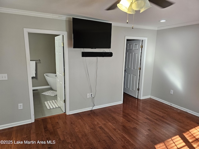 unfurnished bedroom featuring dark wood-type flooring, ceiling fan, a closet, and ensuite bath