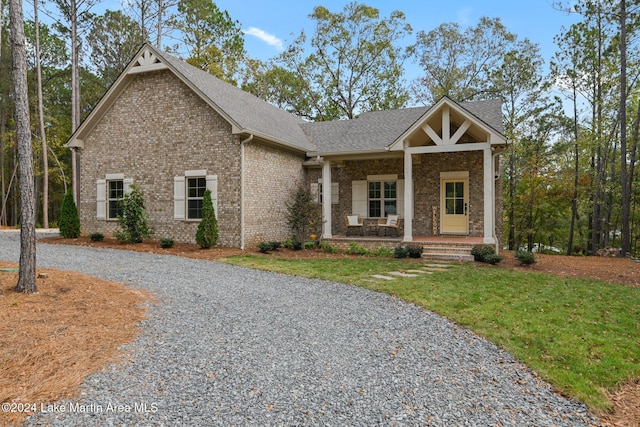 craftsman-style home featuring covered porch and a front yard